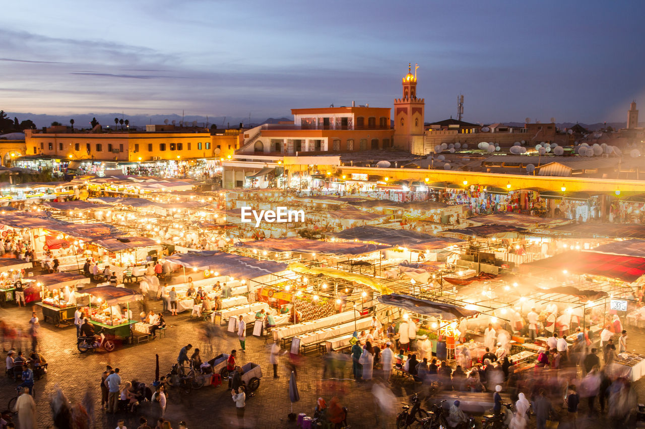 HIGH ANGLE VIEW OF PEOPLE AT MARKET STALL