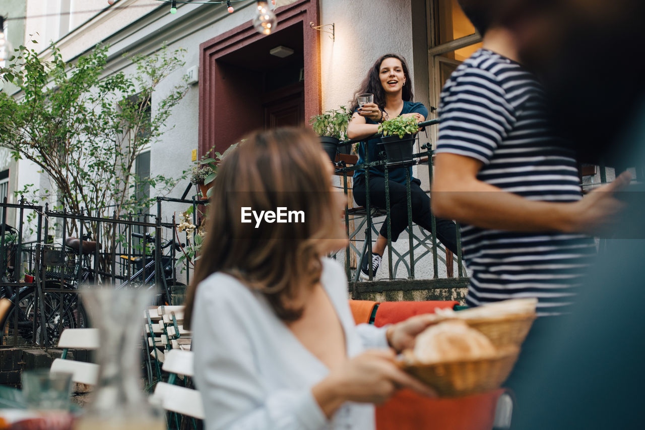 Young male and female friends in backyard during garden party