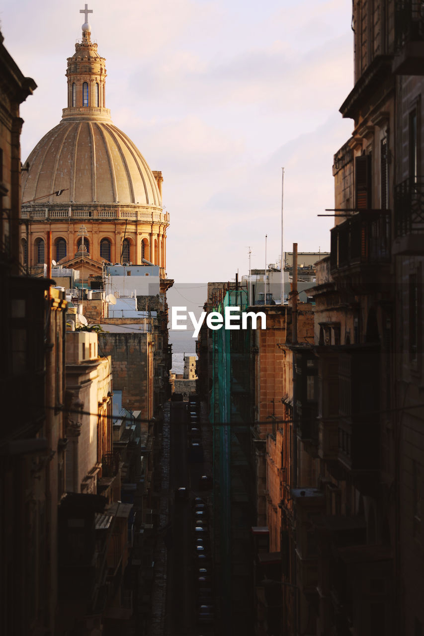 Historical building and a roman catholic church in the streets of valletta, malta.