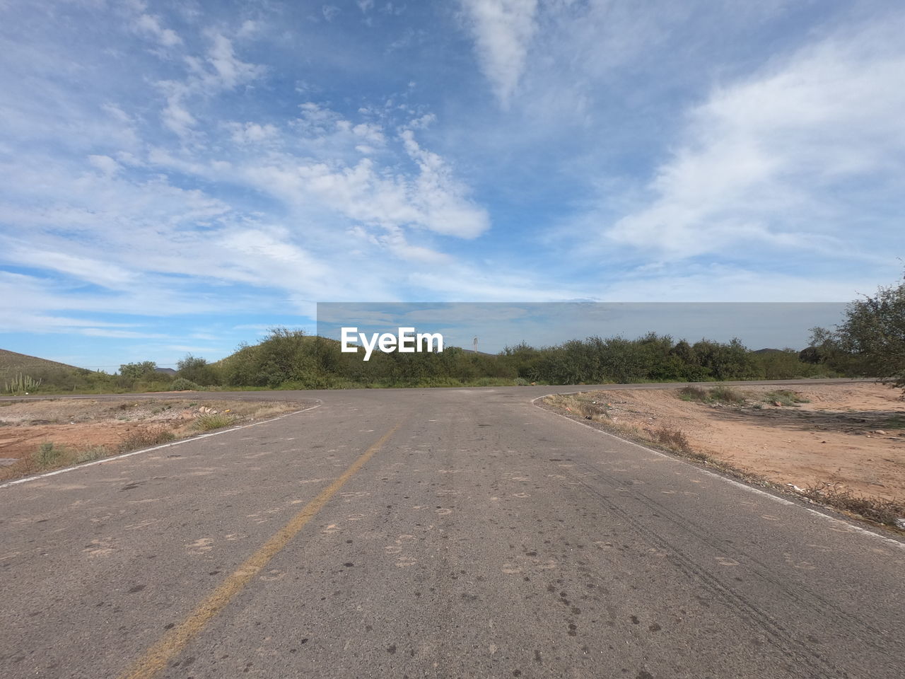 SURFACE LEVEL VIEW OF ROAD AGAINST SKY