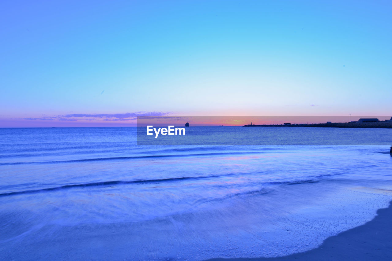 SCENIC VIEW OF BEACH AGAINST CLEAR SKY
