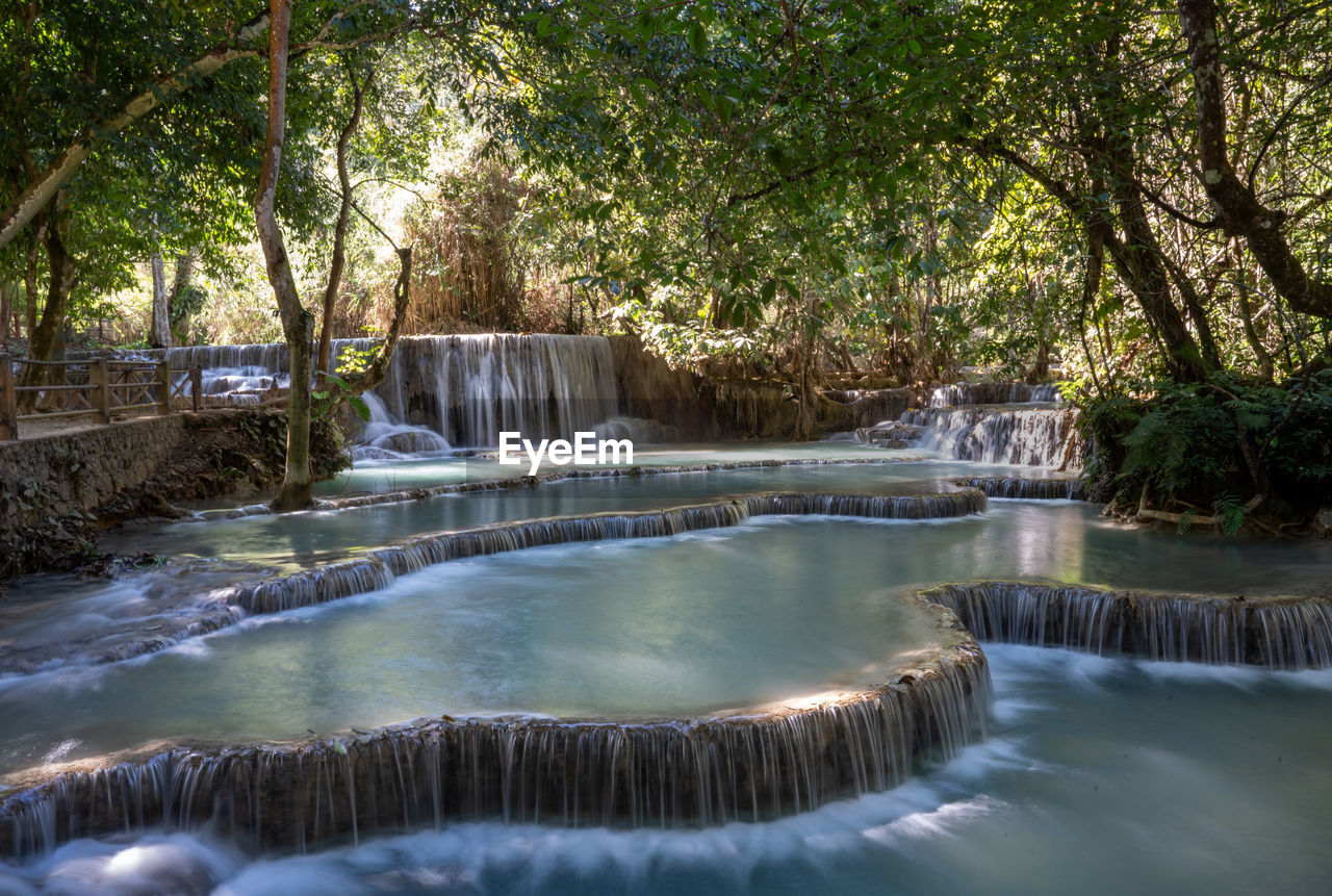 The kuang si waterfall is located 30 km to the south of luang prabang in  laos.