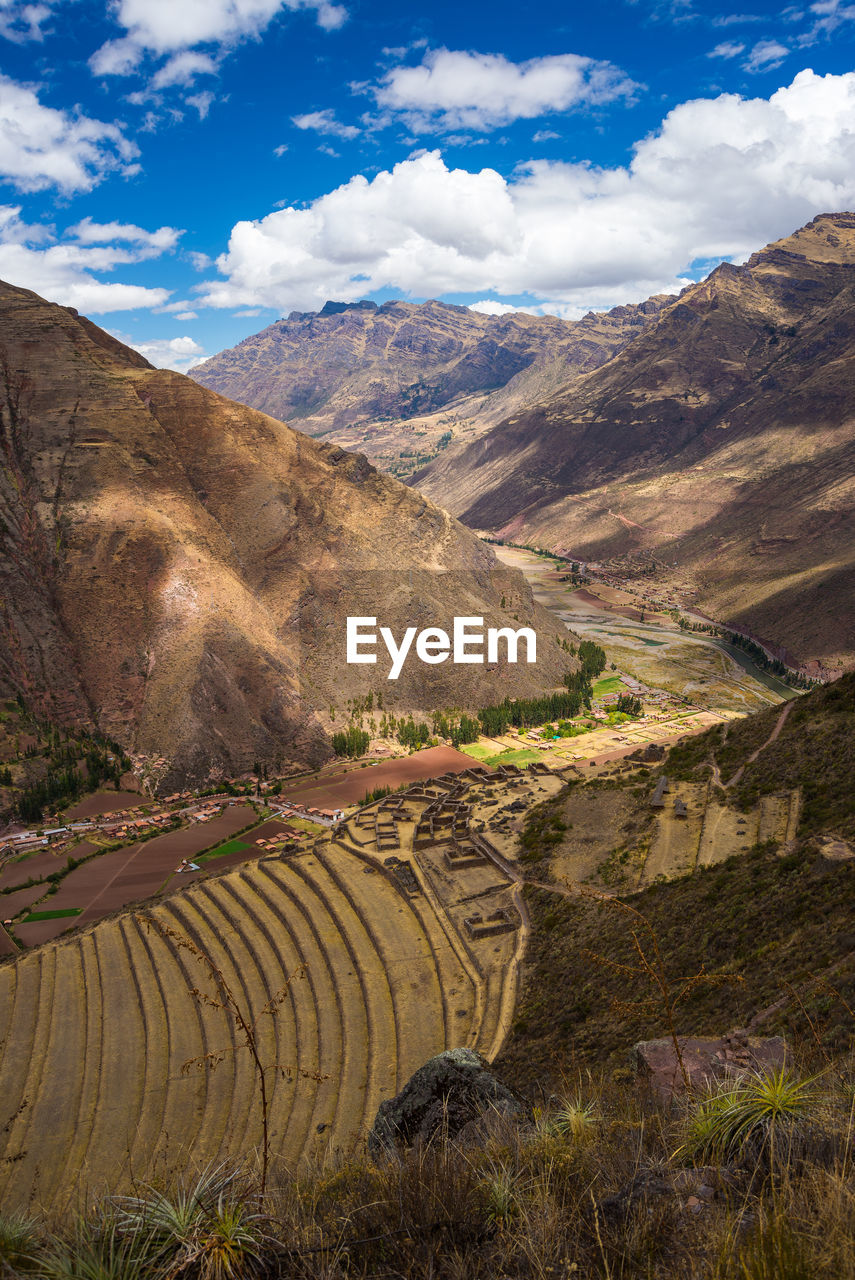 Scenic view of mountains against cloudy sky