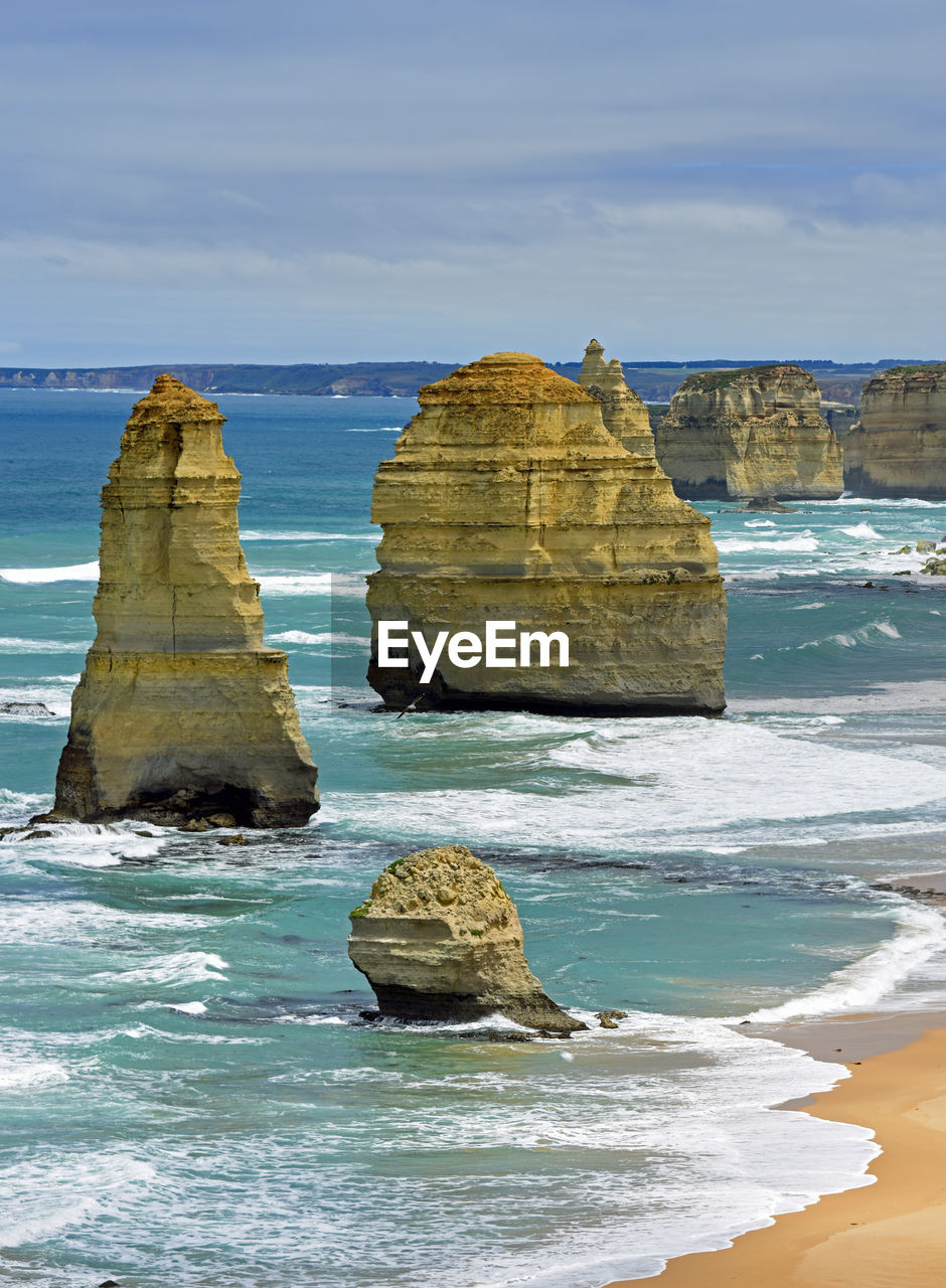 Rock formation in sea against sky