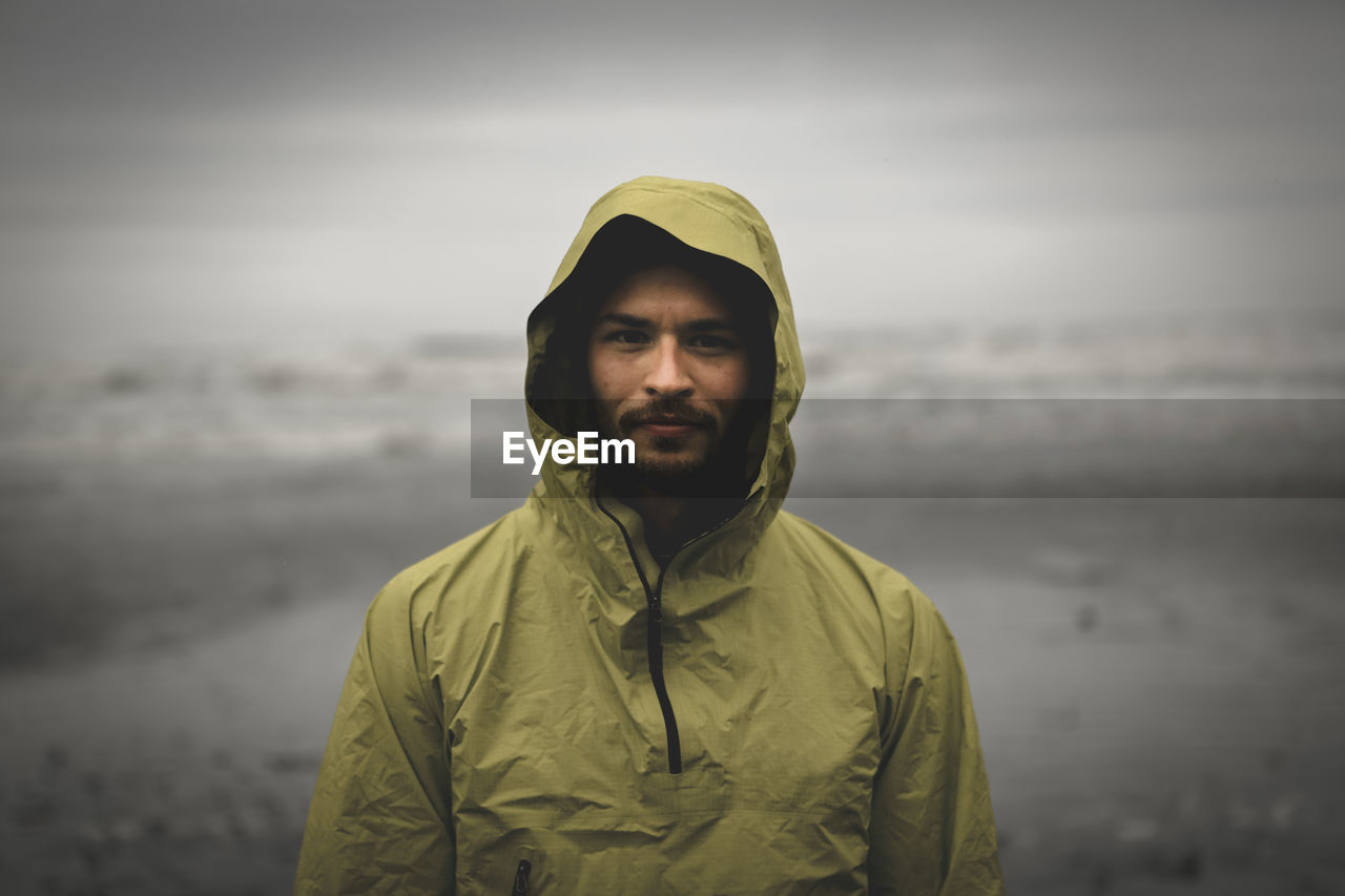 Portrait shot of adventurous looking male during bad weather