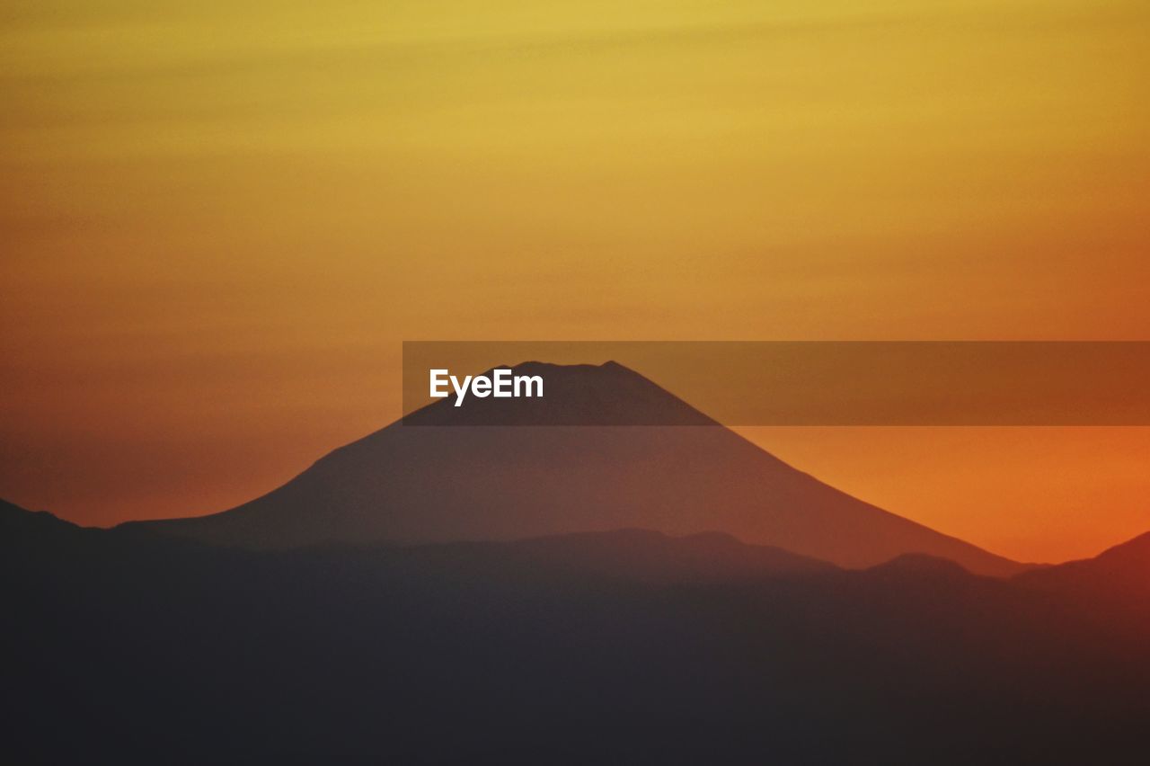 Scenic view of silhouette mountains against sky during sunset