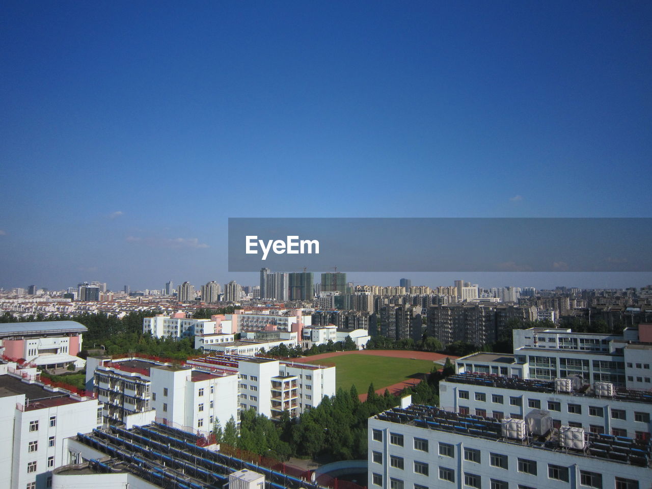 View of cityscape against blue sky