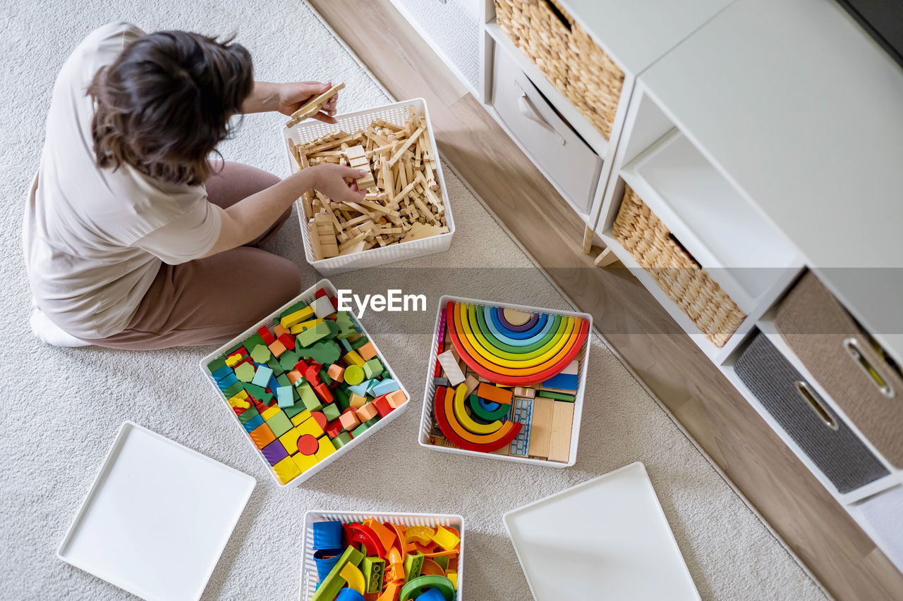 high angle view of girl playing with toys on table