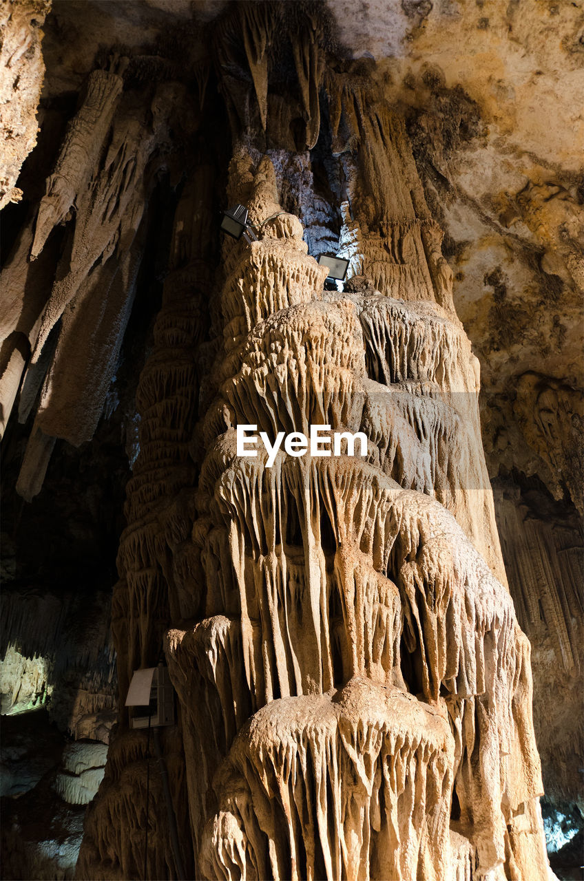 LOW ANGLE VIEW OF ROCK FORMATIONS IN CAVE