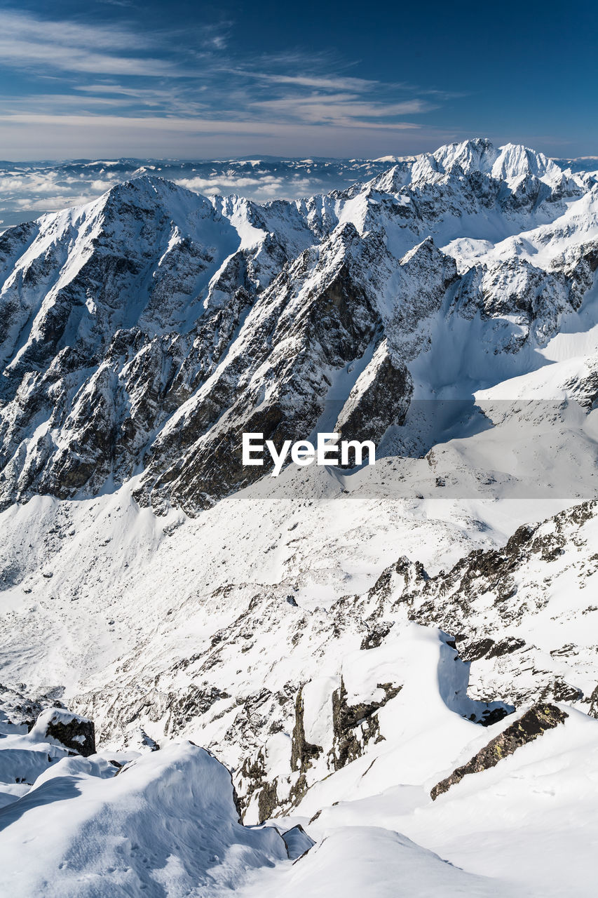 Aerial view of snow covered mountains against sky. view from lomnica, tatra mountains, poland