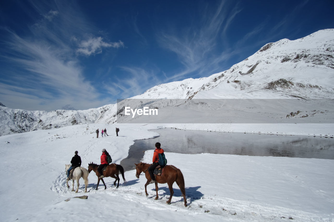 People riding horses on mountain