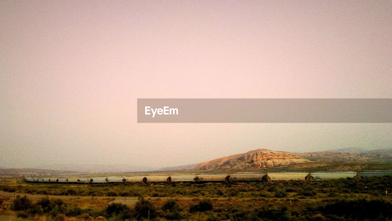 VIEW OF FARM AGAINST CLEAR SKY