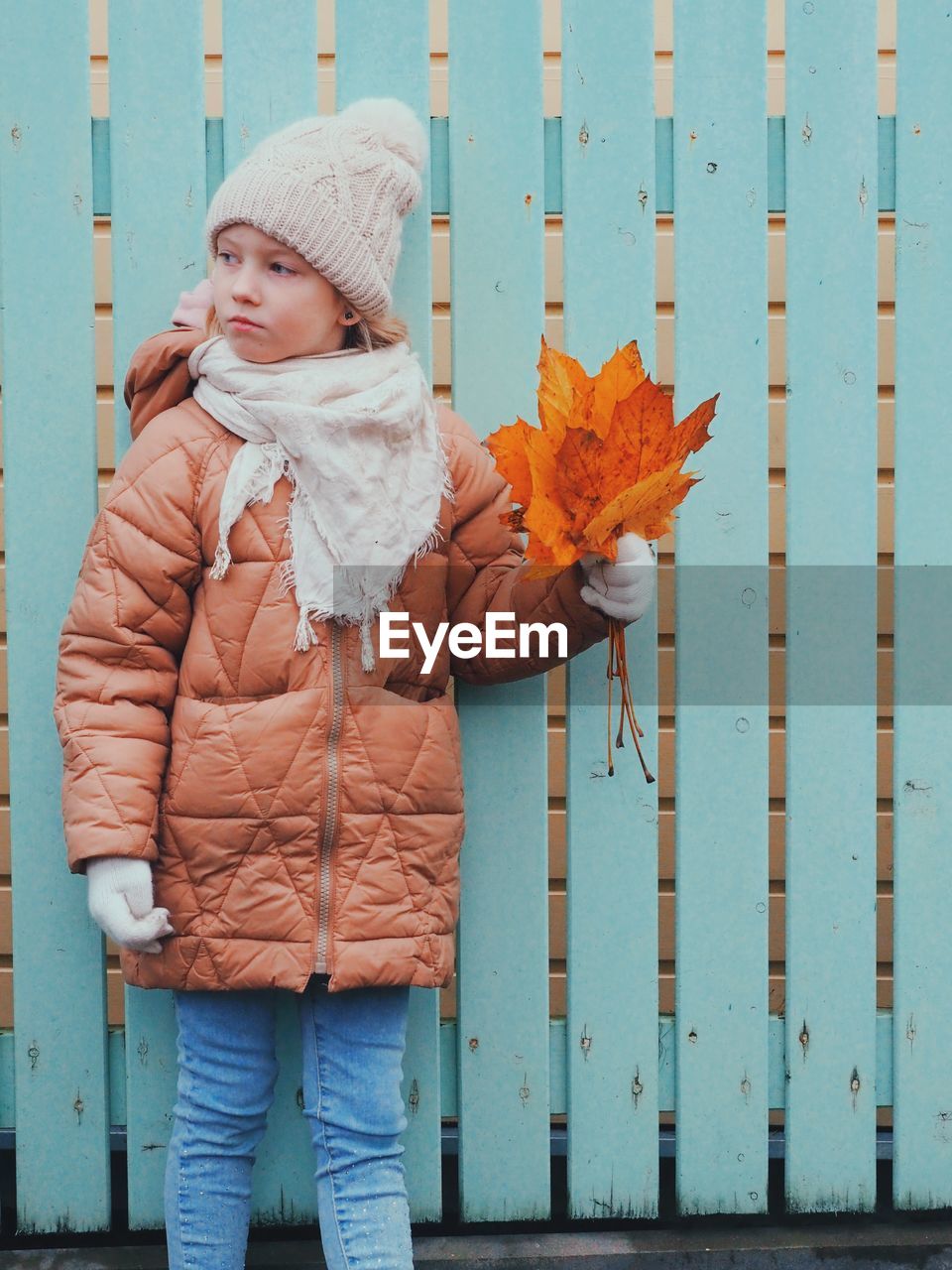 Full length of woman standing in snow during autumn