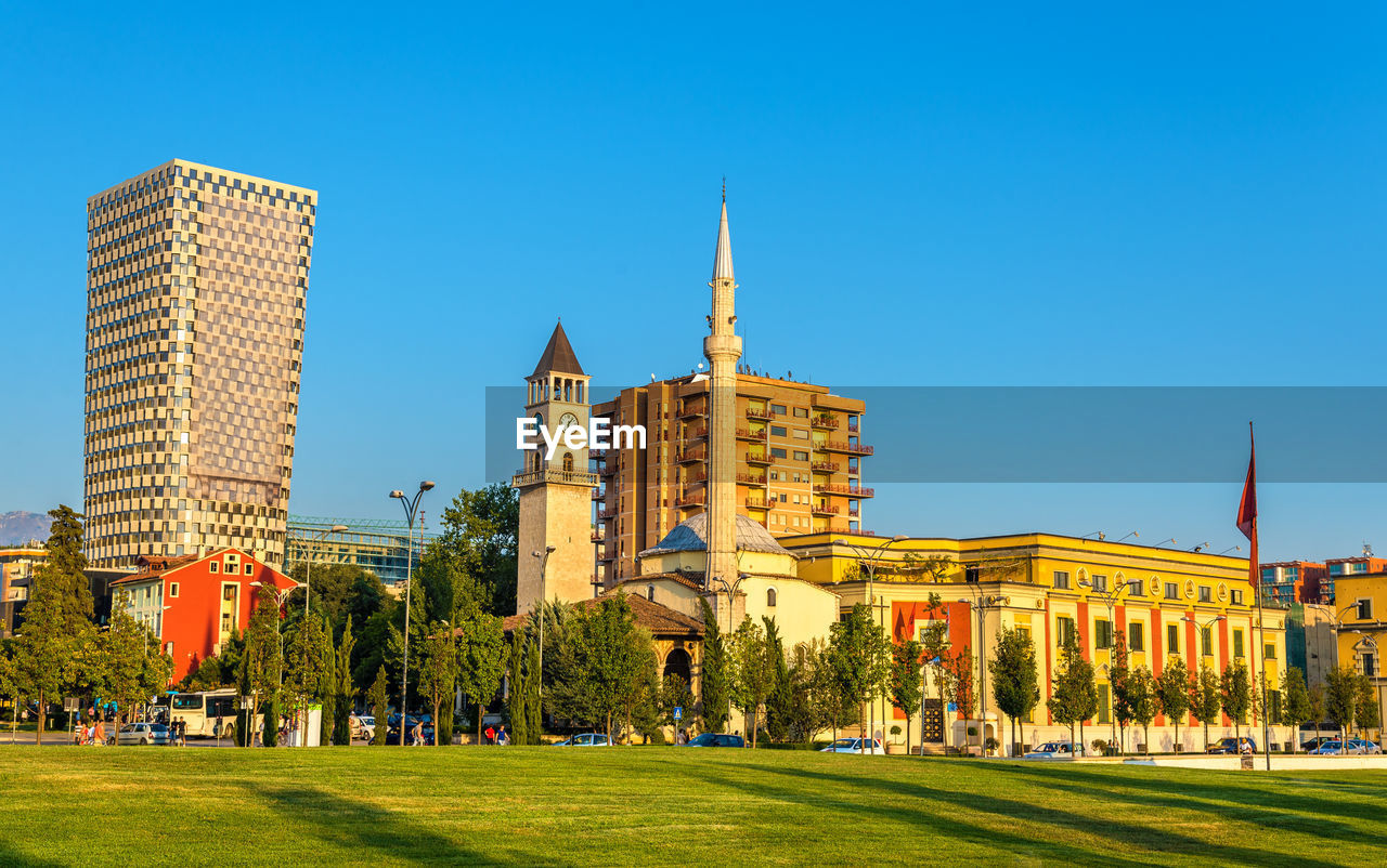 BUILDINGS AGAINST CLEAR BLUE SKY