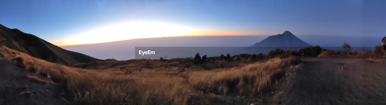 PANORAMIC VIEW OF LAND AGAINST SKY DURING SUNSET