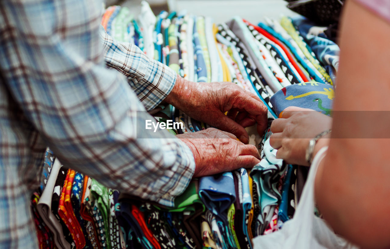 Close-up of people browsing fabrics