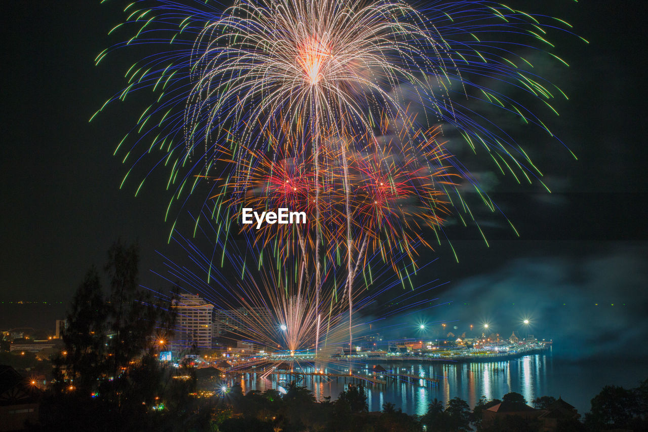 Low angle view of firework display at night