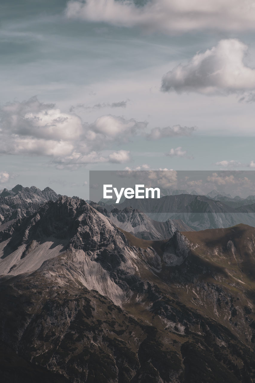 Scenic view of mountains against cloudy sky