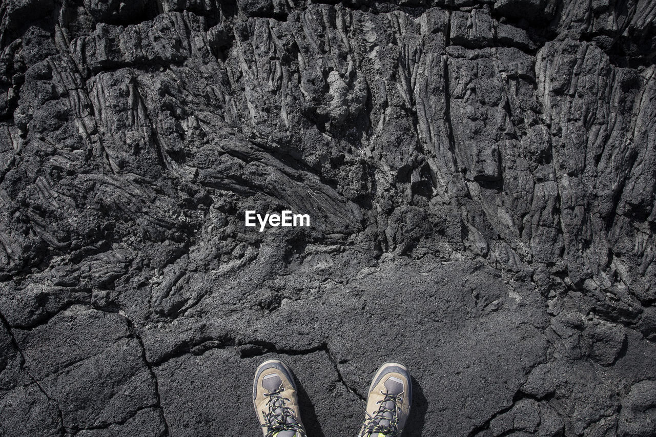 Low section of person standing on rock