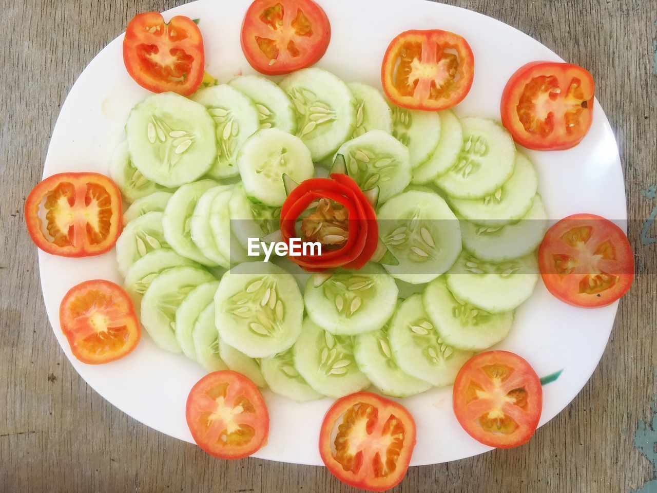 A platter of cucumber and tomatoes slices 