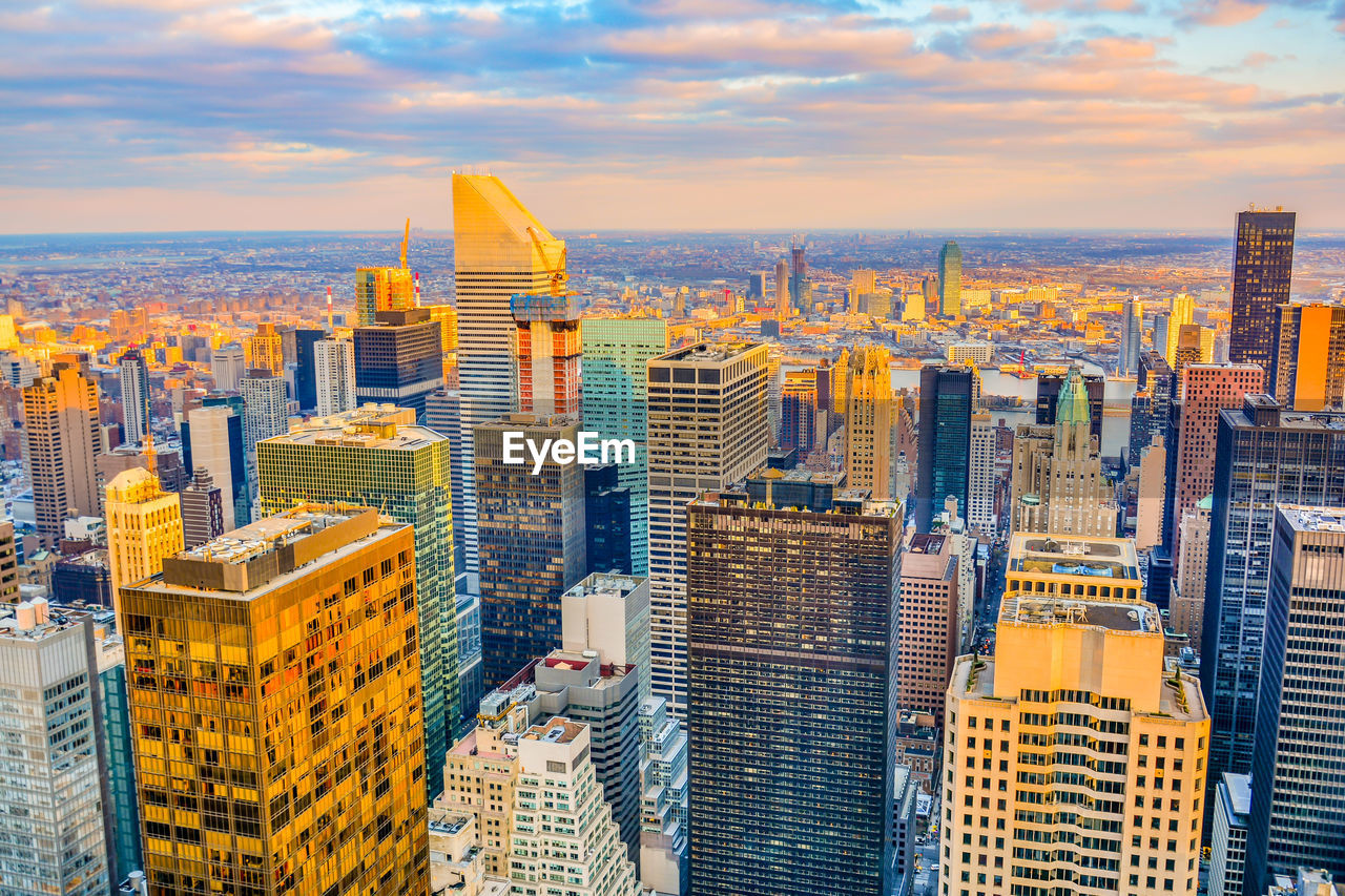 High angle view of cityscape against cloudy sky