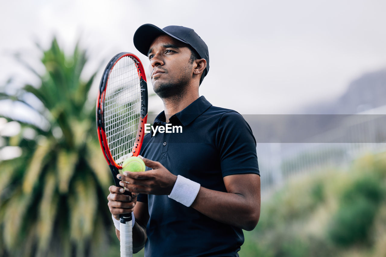 young man holding tennis