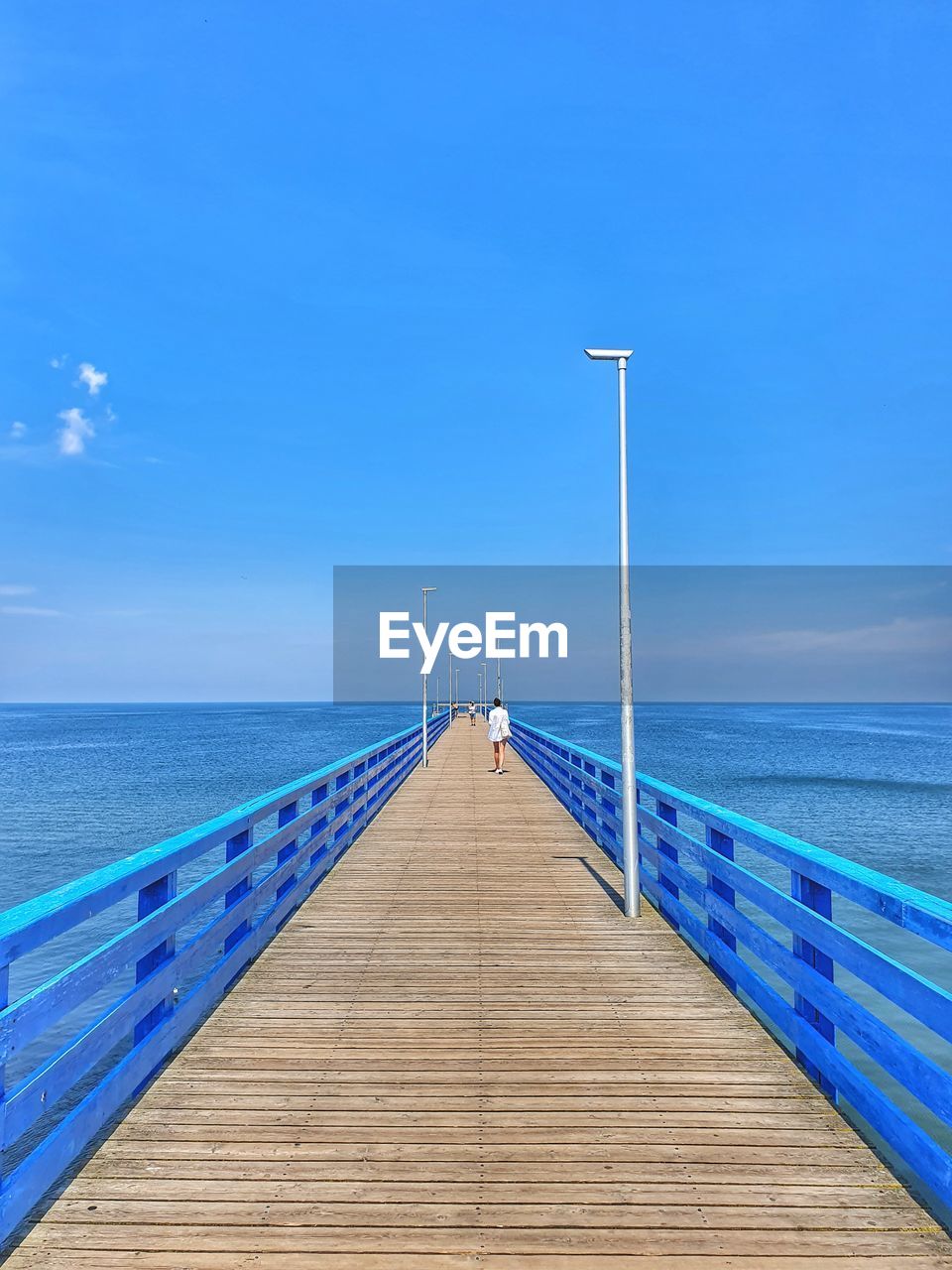 VIEW OF PIER OVER SEA AGAINST BLUE SKY