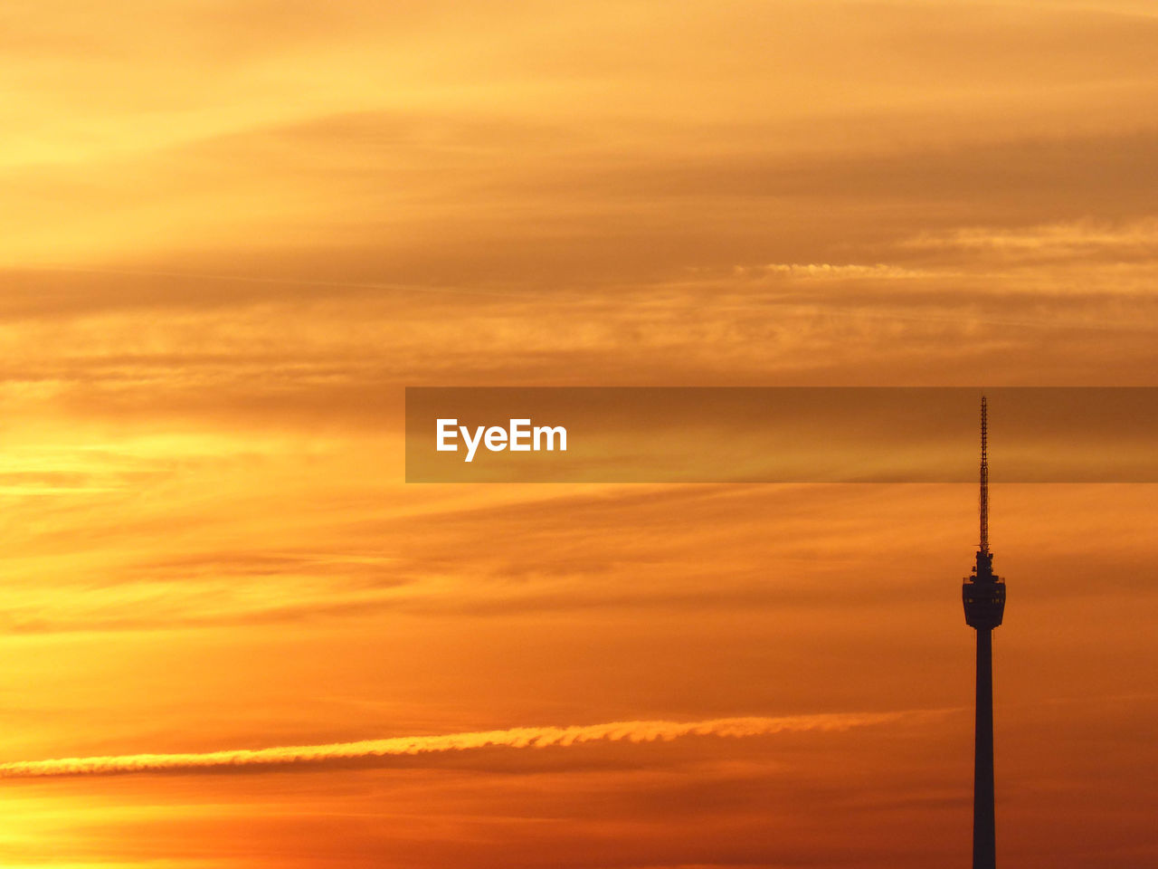 Communications tower against sky during sunset