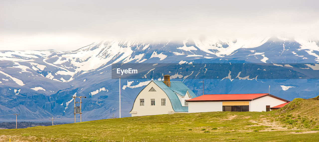 Airport buildings and lighting poles on the edge of an icelandic island.