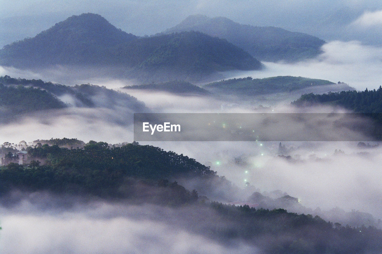 CLOSE-UP OF MOUNTAINS AGAINST SKY