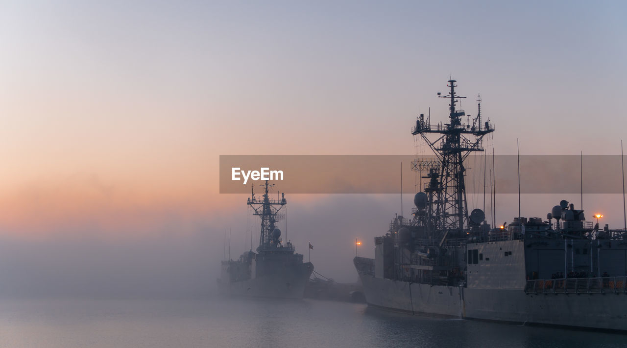 SHIP IN SEA AGAINST SKY AT SUNSET