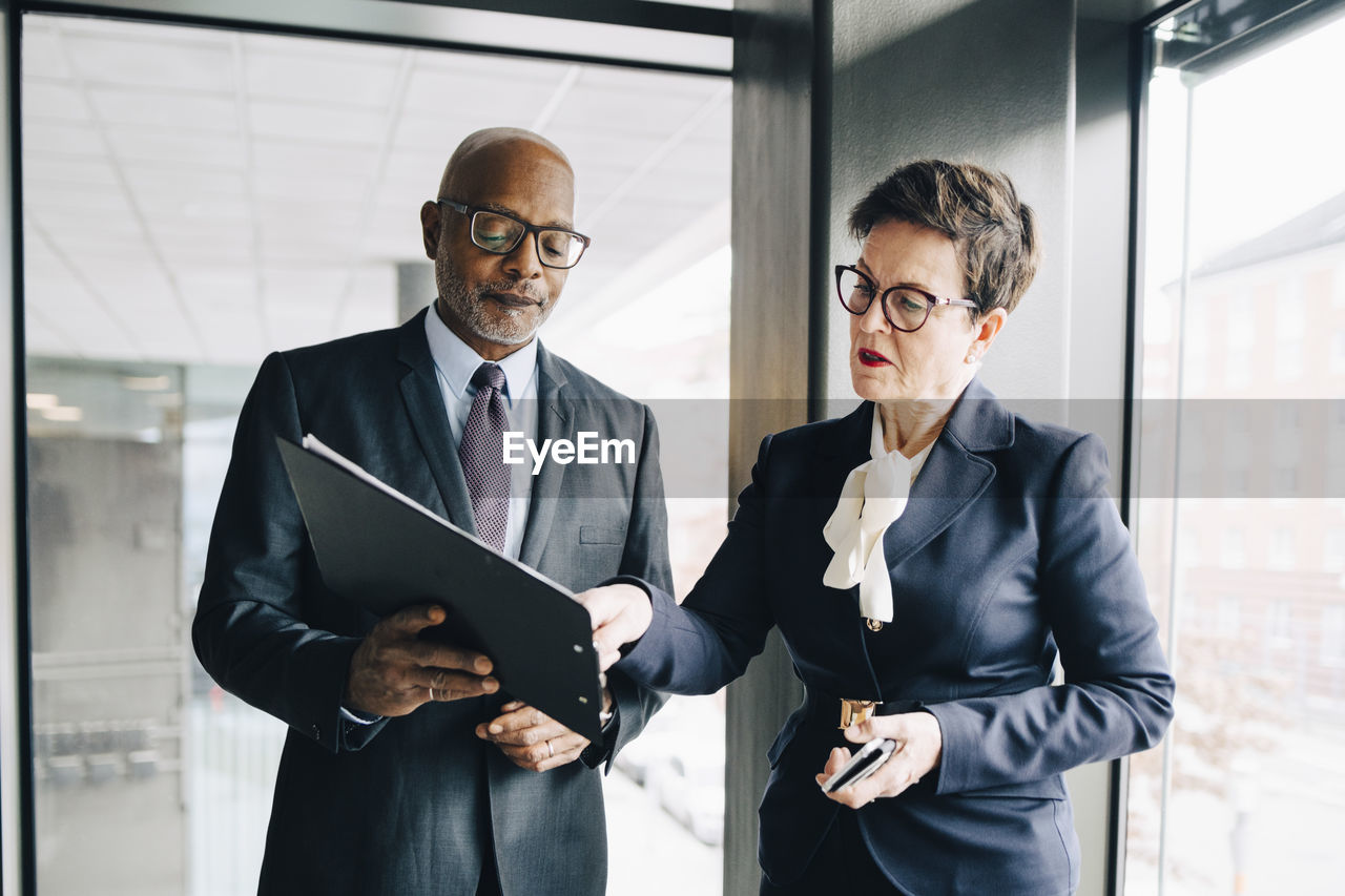 Senior businesswoman explaining strategy to colleague in conference room at office