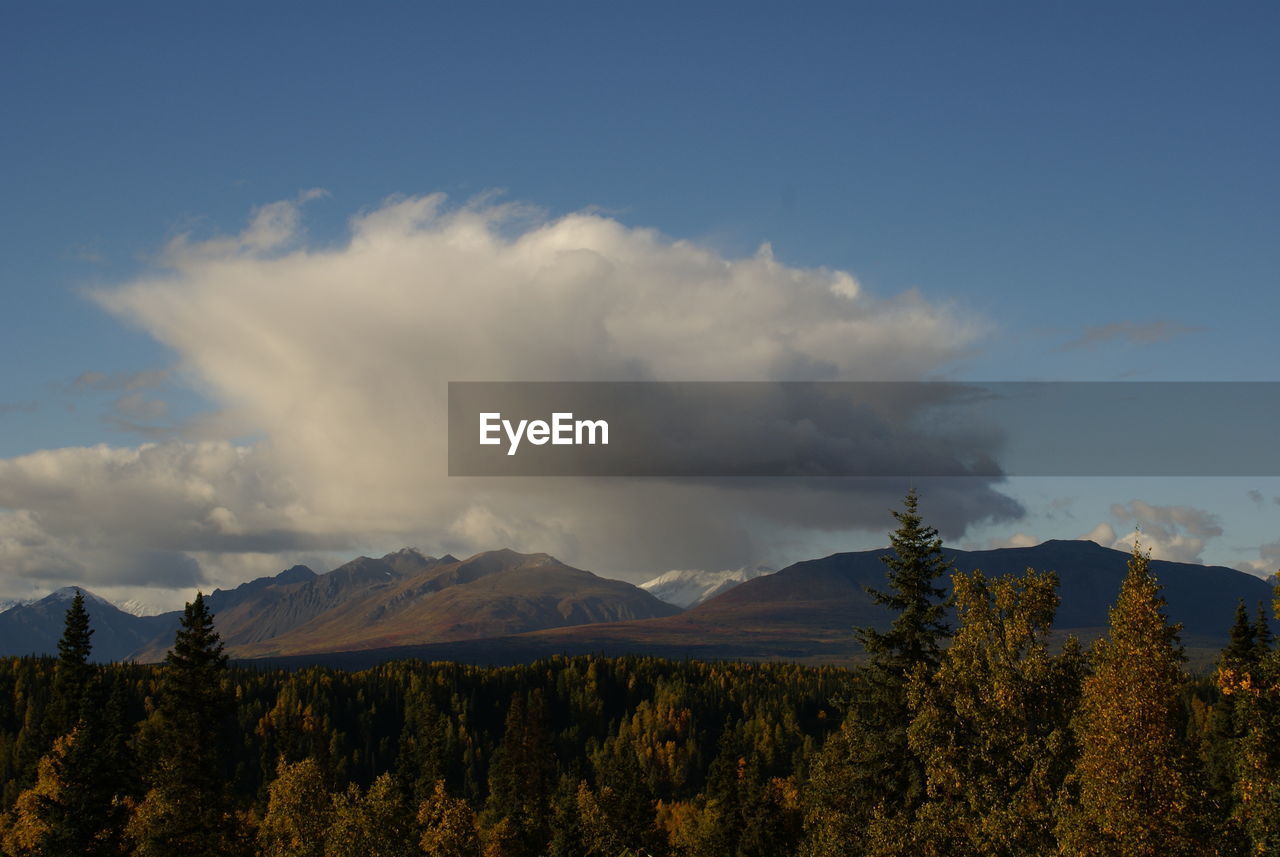 Scenic view of mountains against cloudy sky