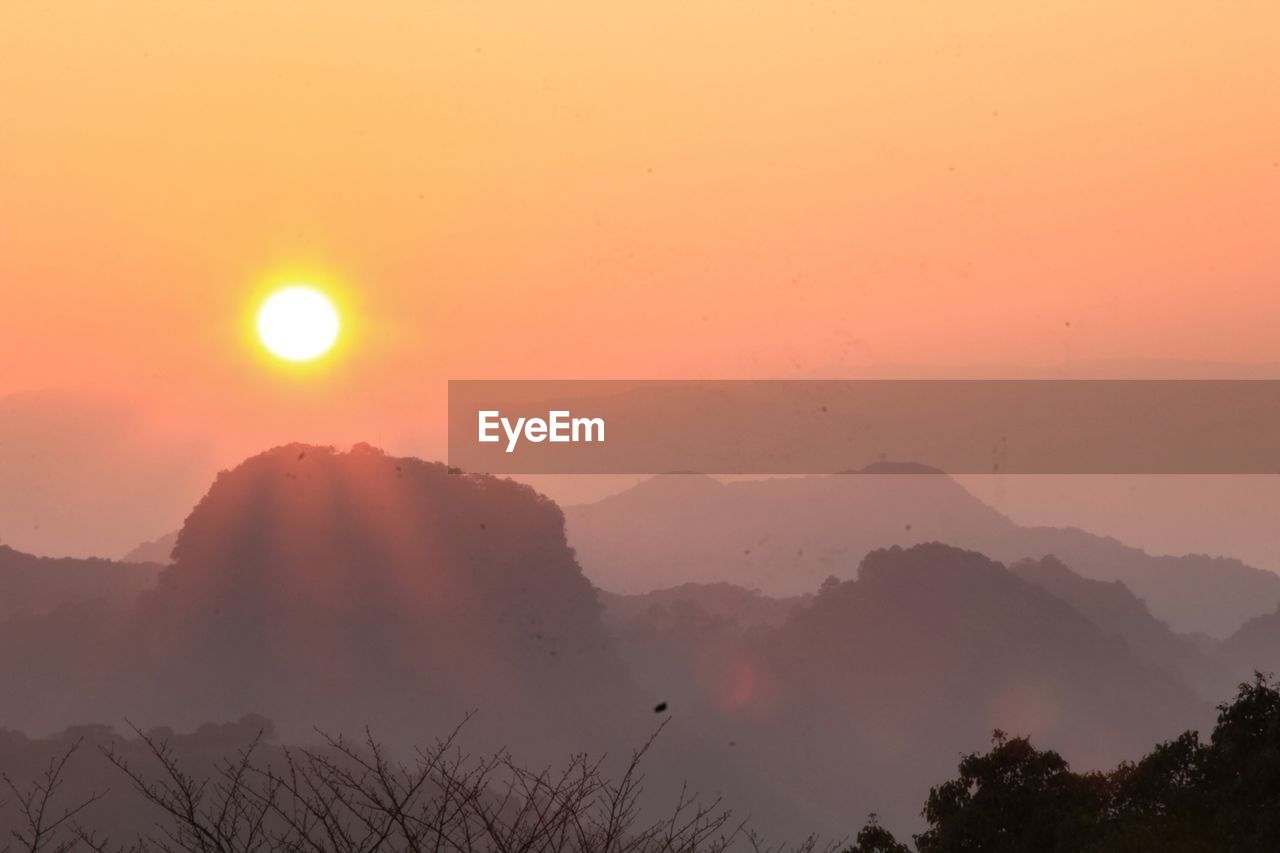 Scenic view of mountains against sky during sunrise