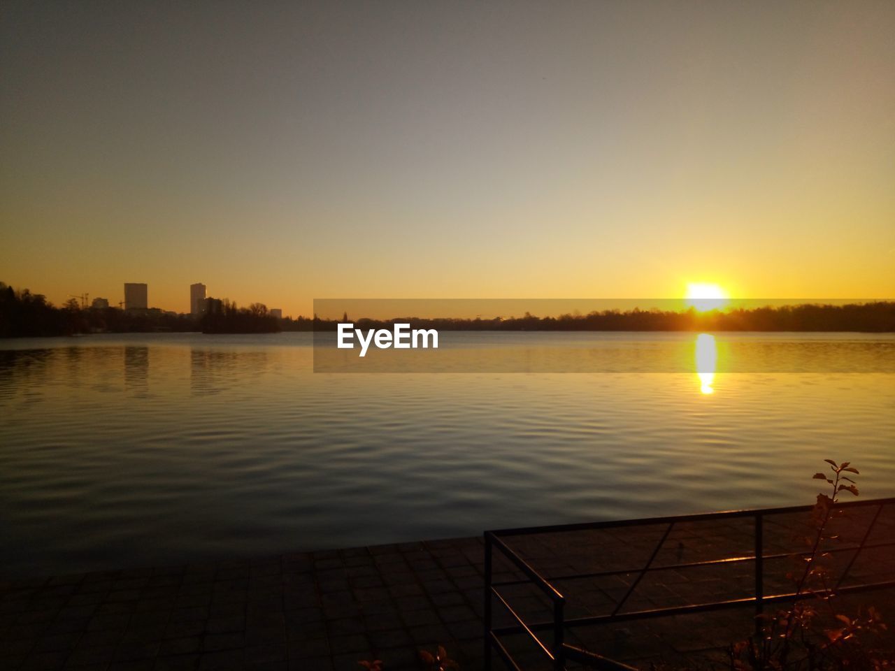 SCENIC VIEW OF LAKE AGAINST ORANGE SKY