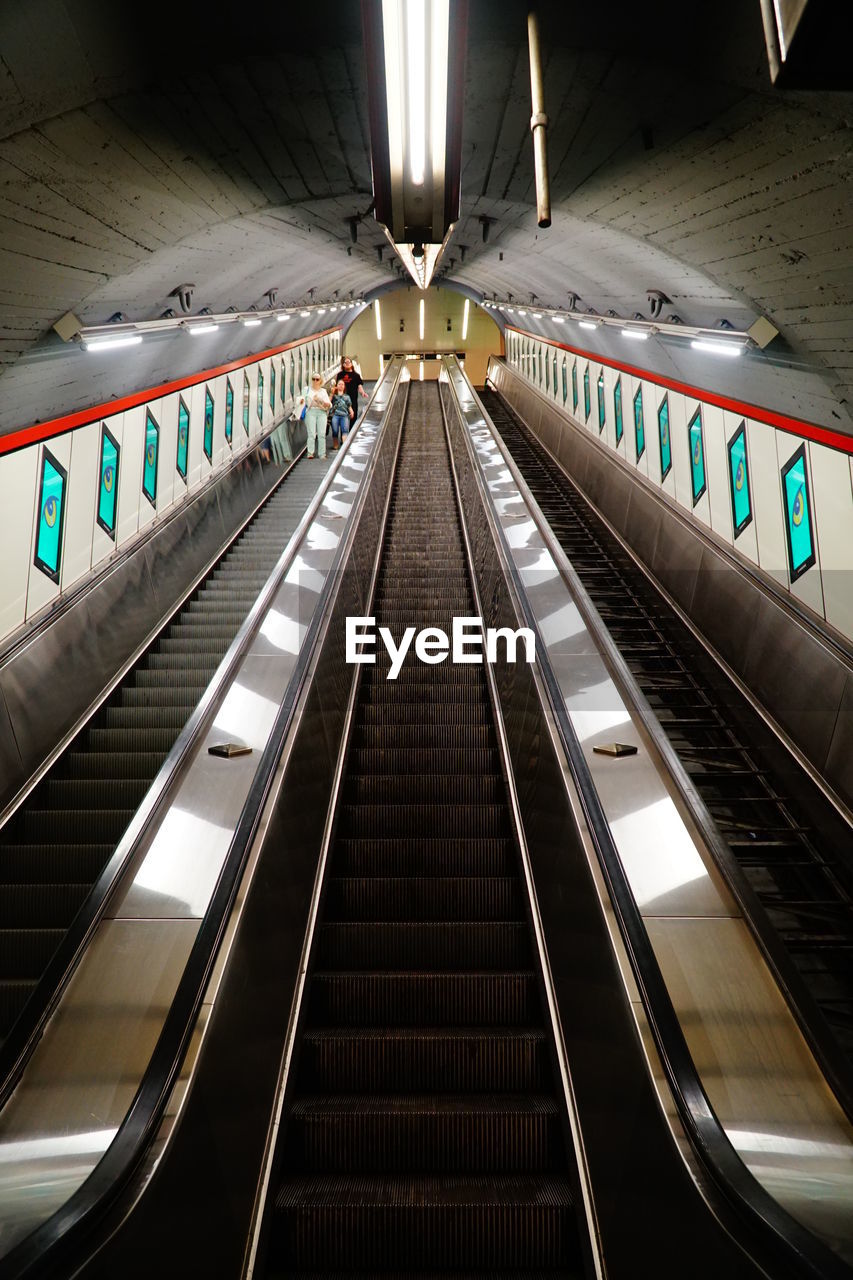 LOW ANGLE VIEW OF ESCALATOR IN SUBWAY STATION