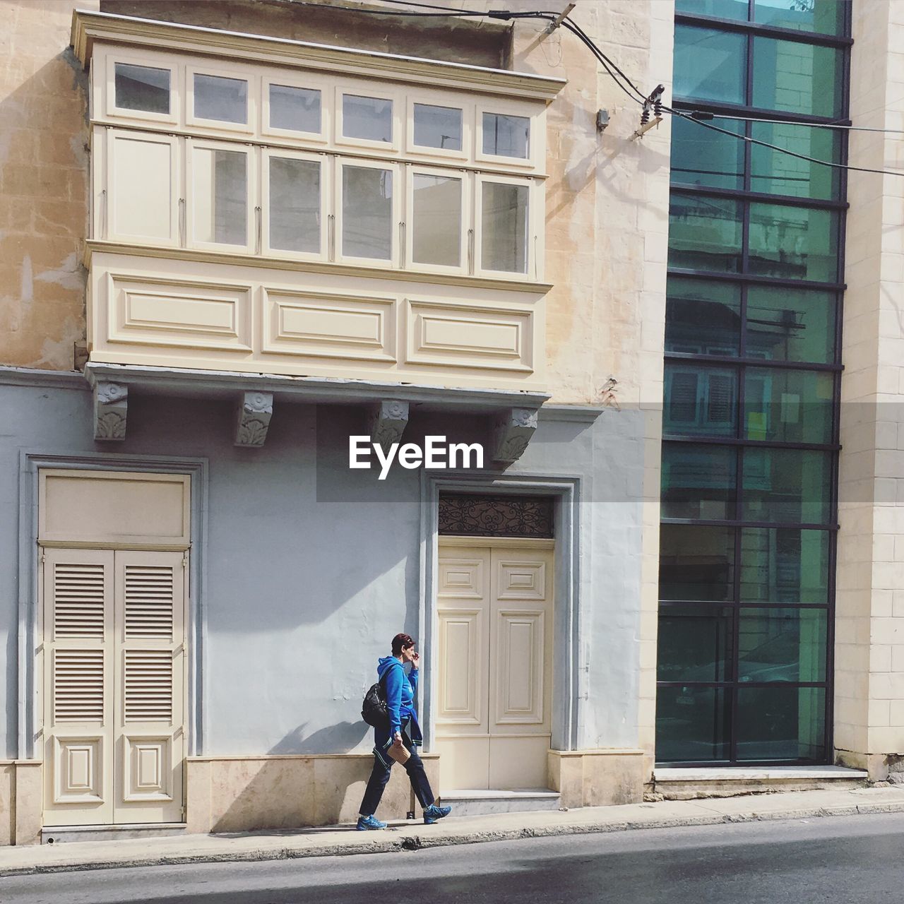 WOMAN WALKING ON CITY STREET