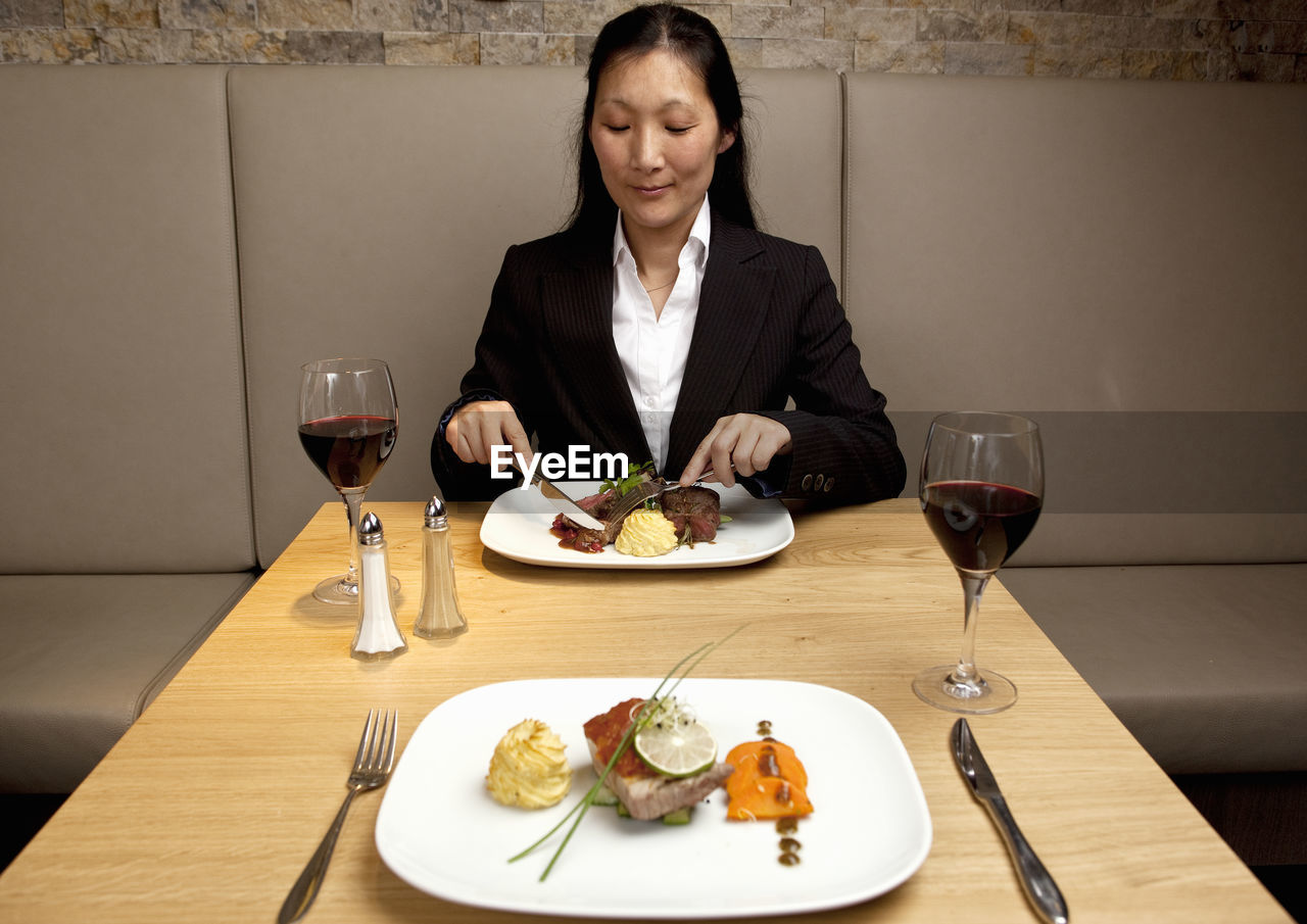 Businesswoman eating at restaurant in a luxury hotel