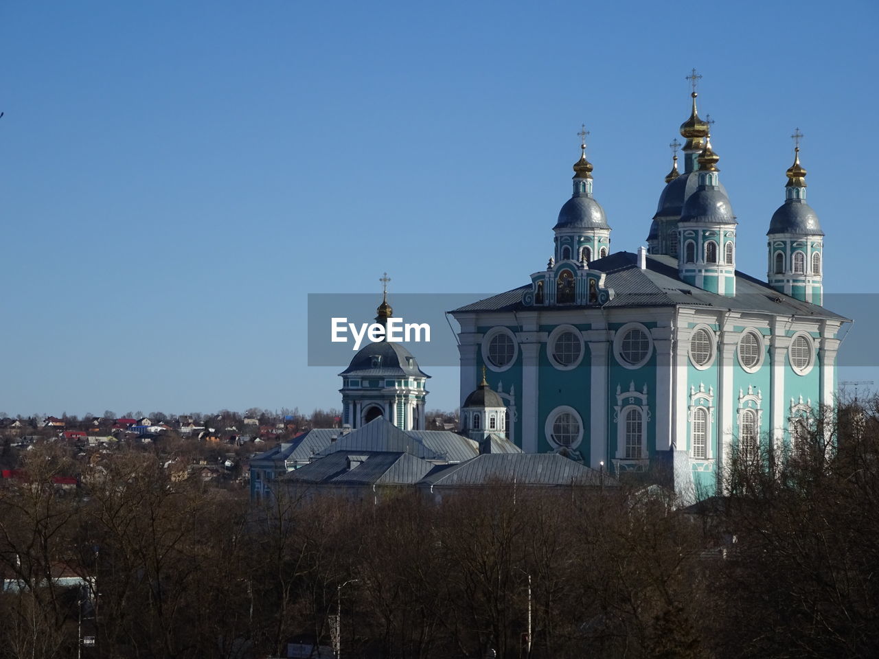 architecture, building exterior, built structure, sky, landmark, religion, dome, place of worship, travel destinations, belief, building, nature, spirituality, clear sky, blue, city, travel, no people, catholicism, history, the past, worship, tower, tourism, plant, tree, outdoors, day, sunny