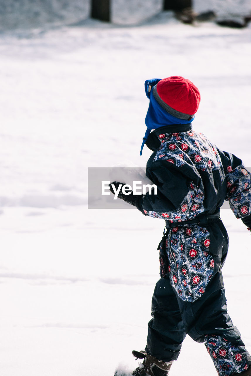 Boy on snow covered field