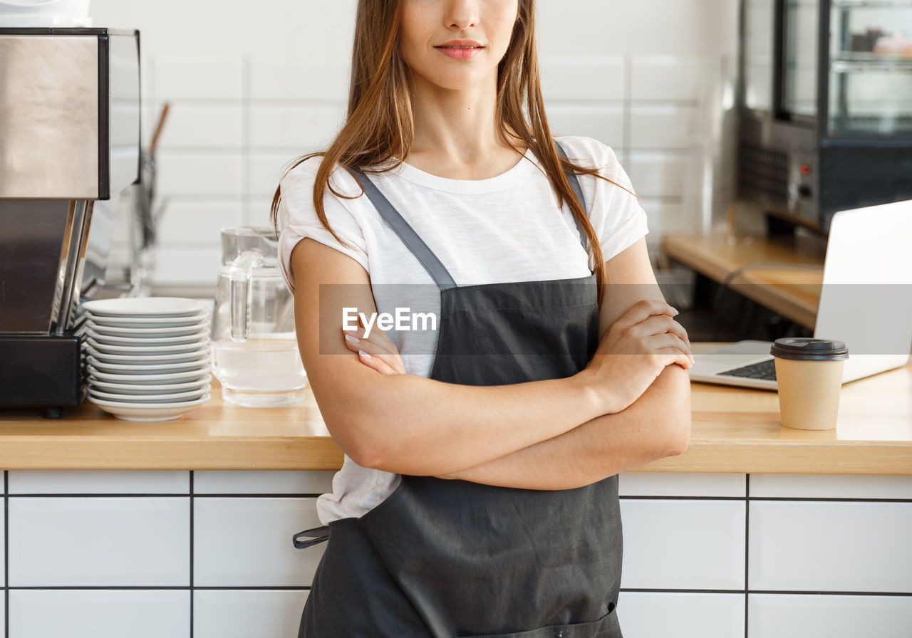 Midsection of woman standing at home