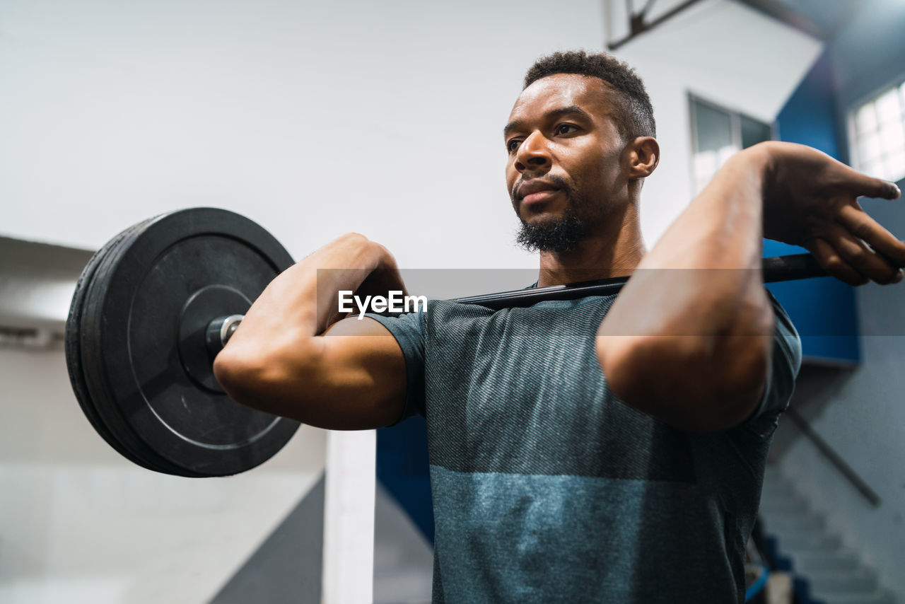 Man lifting weights in gym