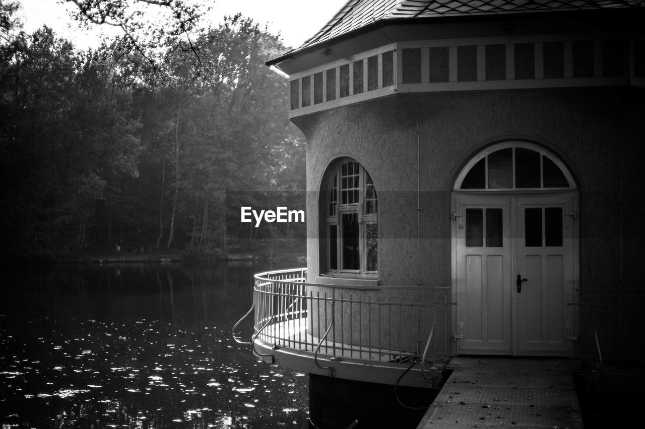 Built structure by lake against sky