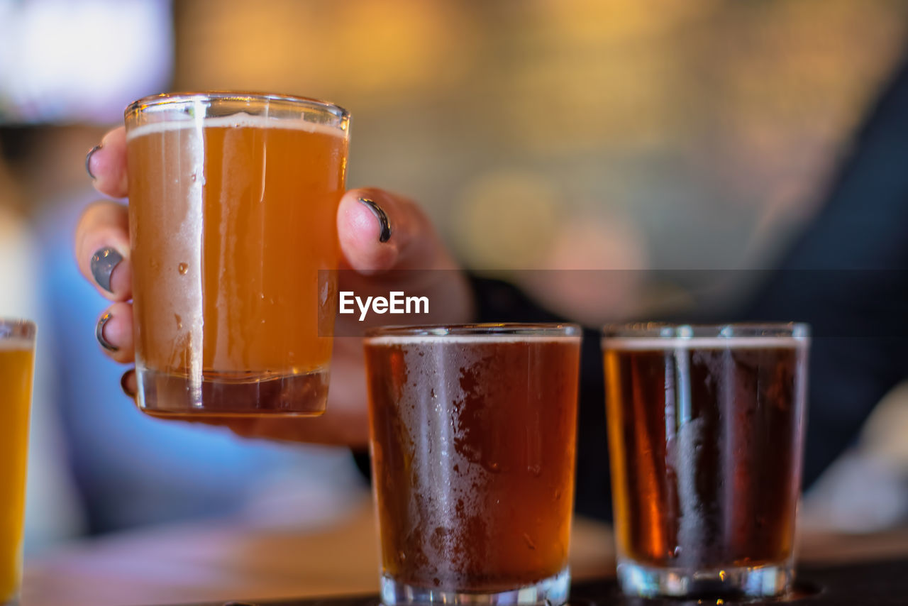 Closeup of woman enjoying a beer flight