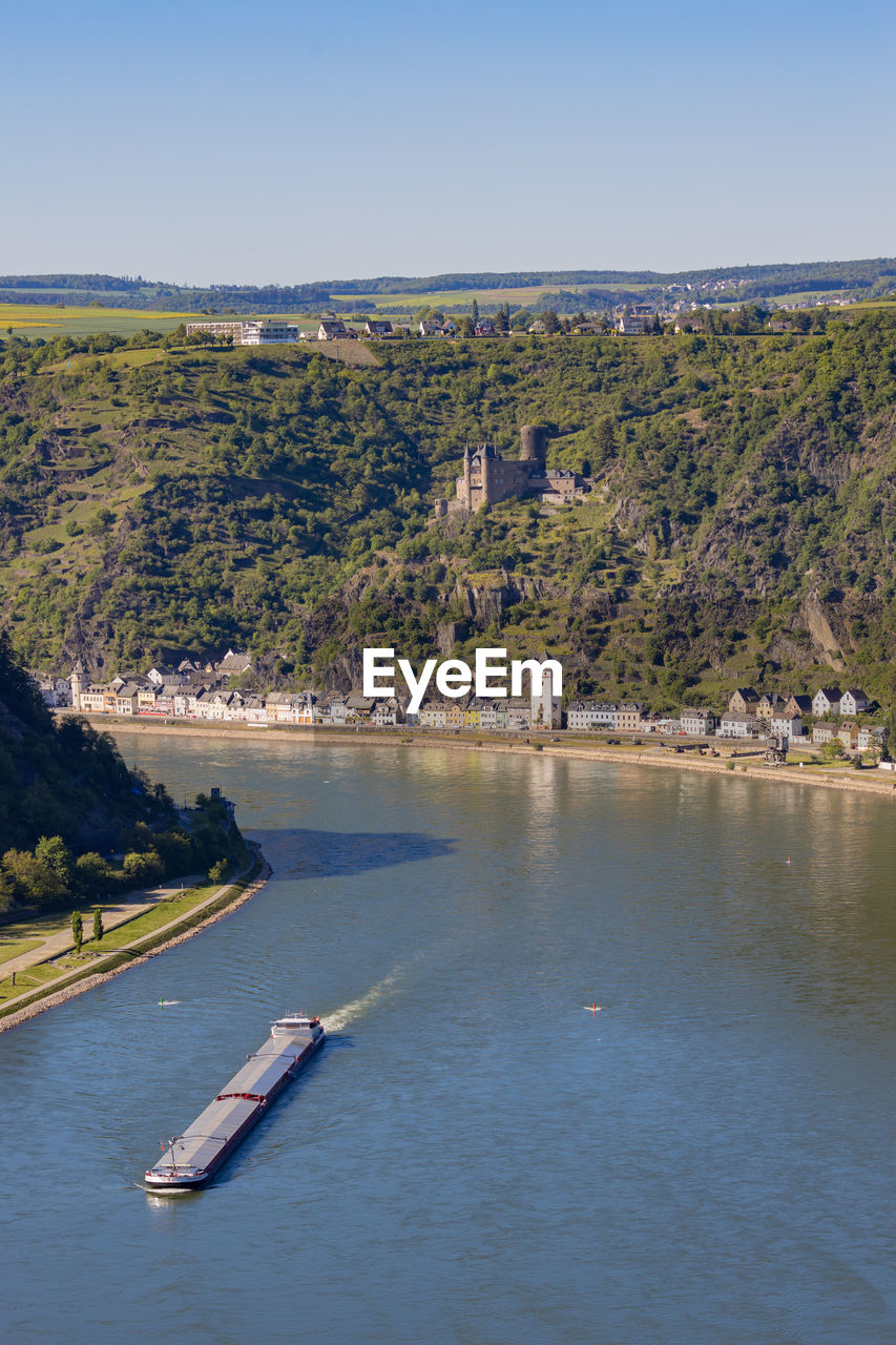 Scenic view of river by trees against sky