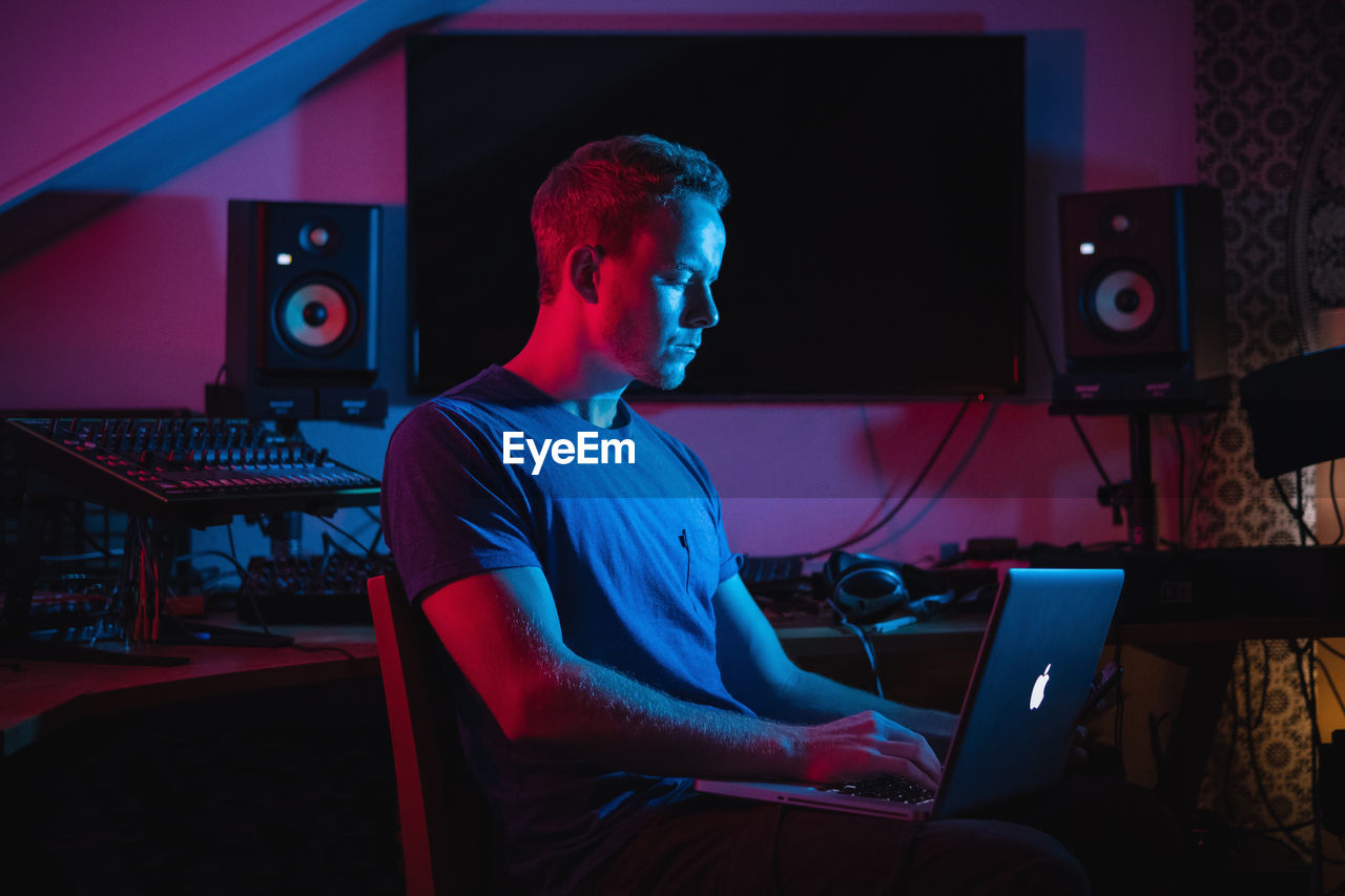 Young man using laptop while sitting at home