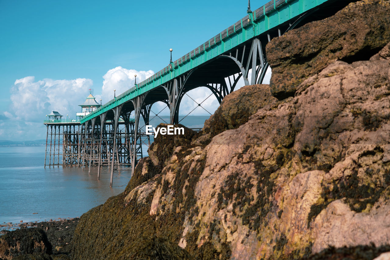 Panoramic photo of clevedon pier in somerset showing iron structure against blue sky