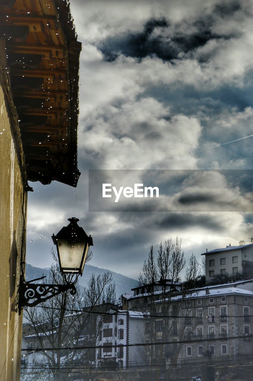 Low angle view of buildings against cloudy sky