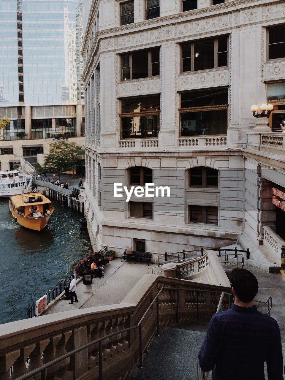 PEOPLE SITTING ON BOAT IN RIVER