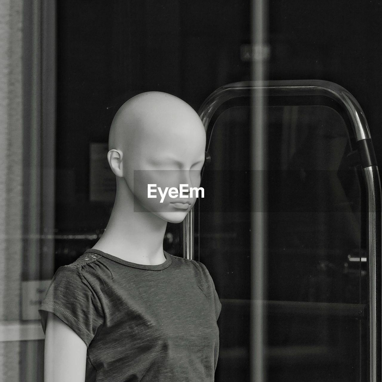 Mannequin seen through store window